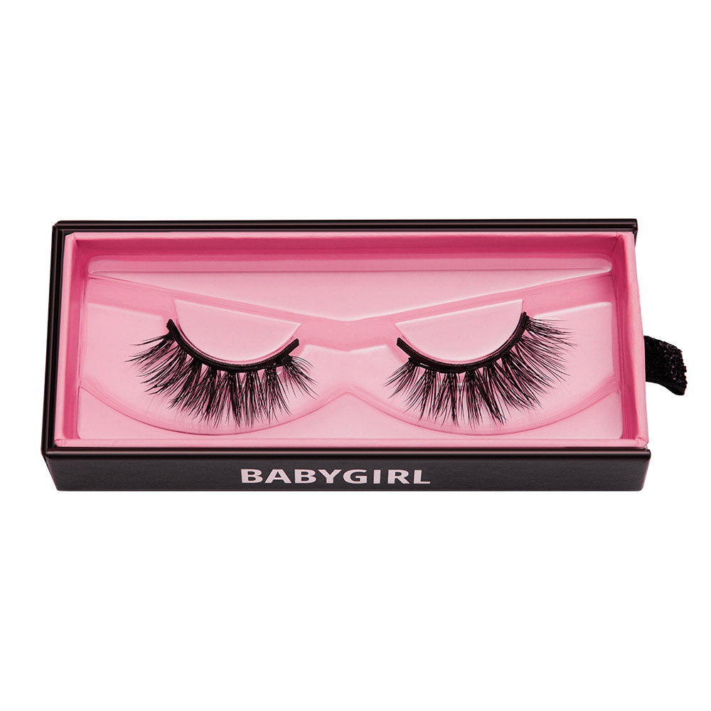 A pair of dramatic Babygirl vegan reusable lashes by glamnetic, packaged in a pink-lined rectangular box with BABYGIRL in white letters—perfect for adding bold glamour to any look.