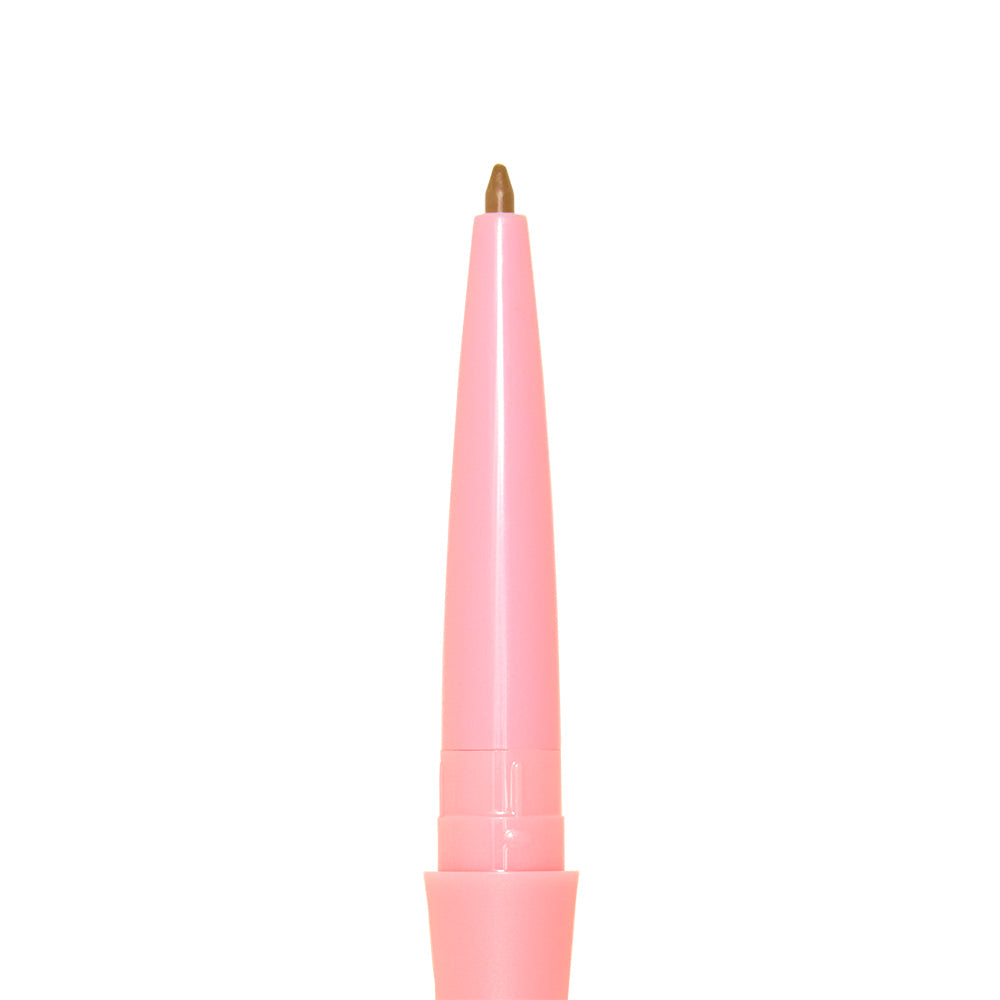 A close-up of the glamnetic 3-in-1 Brow It All mechanical brow pencil in pink, with its brown tip extended, set against a white background.