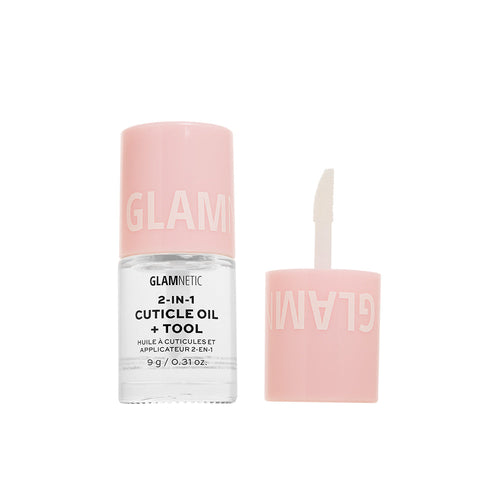 A clear bottle of glamnetic 2-in-1 Cuticle Oil with a pink cap, shown removed to reveal the brush applicator for easy application and healthy nails.