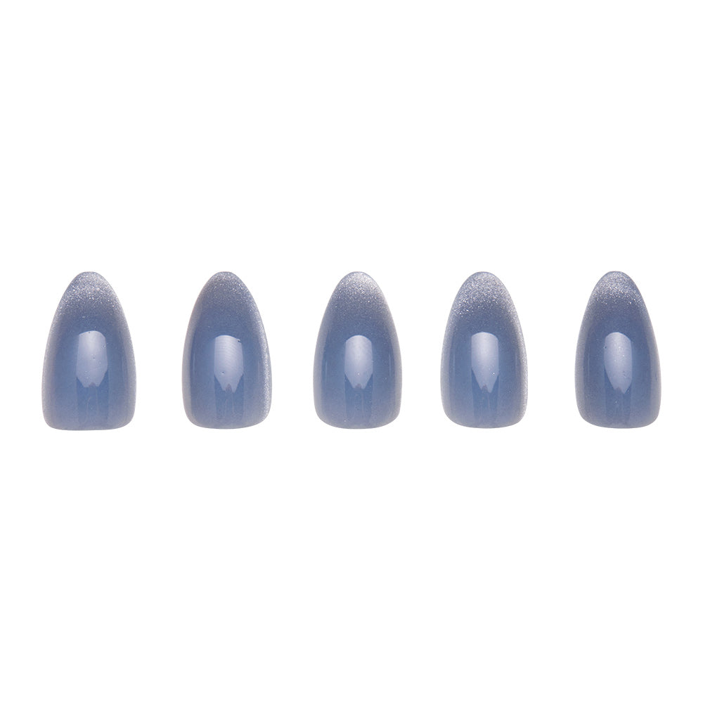 Five glamnetic Baby Blues artificial nails, each in a shiny grayish-blue pastel with a velvet metallic finish, are displayed in a row on a white background.