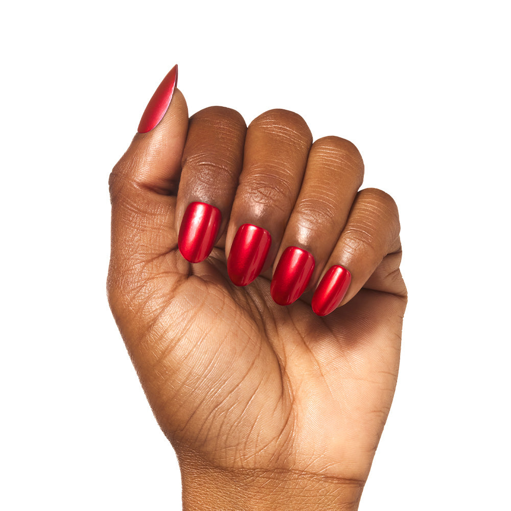 A hand with medium brown skin shows off neatly manicured, short round nails painted in glamnetic’s Cherry Glaze, a glossy cherry-red shade, against a white background.