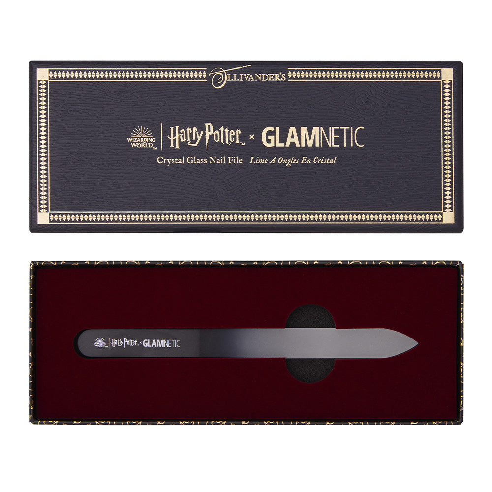 The Harry Potter™ Crystal Glass Nail File by glamnetic comes in an open dark box with gold edging, red velvet lining, and the Ollivanders logo. The black file features silver text—a magical press-on manicure essential.