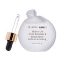 A round frosted bottle labeled Harry Potter™ Press-On Nail Remover by glamnetic, with a gold and black dropper cap, containing 30 mL (1.01 fl oz) of gentle, acetone-free formula, lies beside it.