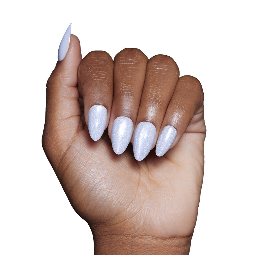 A hand with medium brown skin shows short, almond-shaped nails painted in glamnetics Frozen—a shimmery, pale lavender—against a white background.