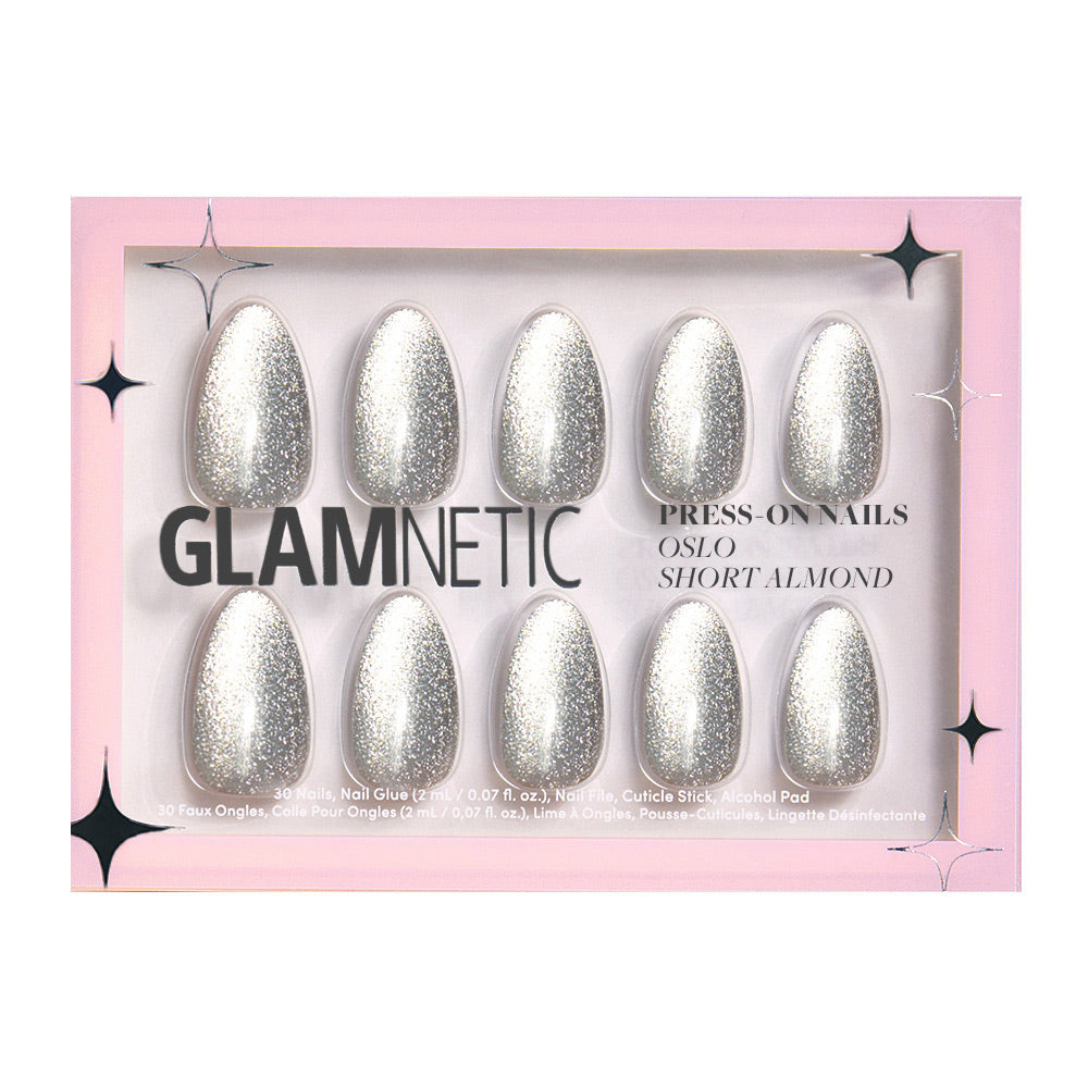 The glamnetic Oslo set features ten short almond-shaped silver glitter press-on nails, packaged in a pink box labeled Press-On Nails and Oslo Short Almond, with black star accents.