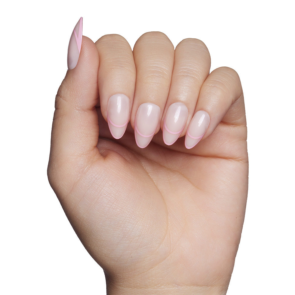 The glamnetic Hot Take nail set features short, almond-shaped tips in a light pink French style with a modern twist—rounded pink tips outlined against a crisp white background.