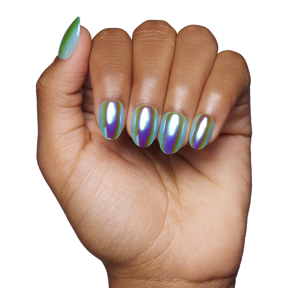 A hand with medium brown skin and short oval nails, neatly manicured and painted in glamnetic’s Siren—a holographic polish with iridescent green, blue, and purple tones—set against a white background.