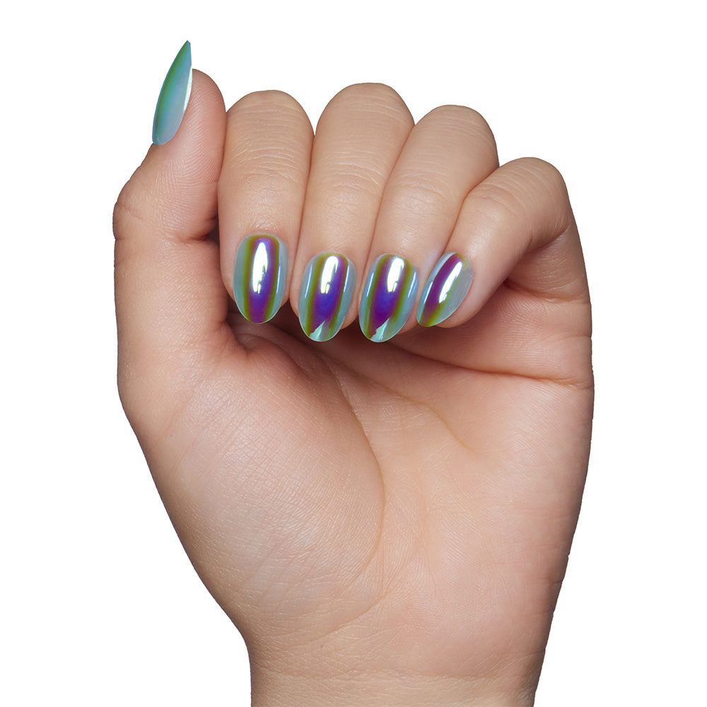 A hand with short, almond-shaped nails from glamnetics Siren set displays a shiny, holographic green and purple finish against a white background.
