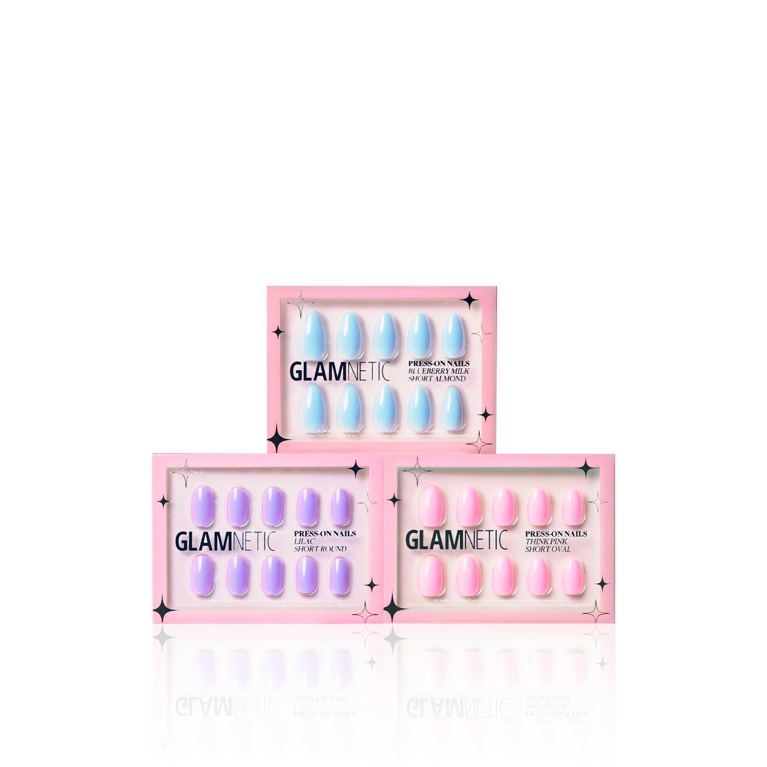Three boxes of glamnetic Blooming Buds press-on nails are stacked in a triangle. Each box features a pink border and clear windows, revealing pastel shades for a playful pop of color.