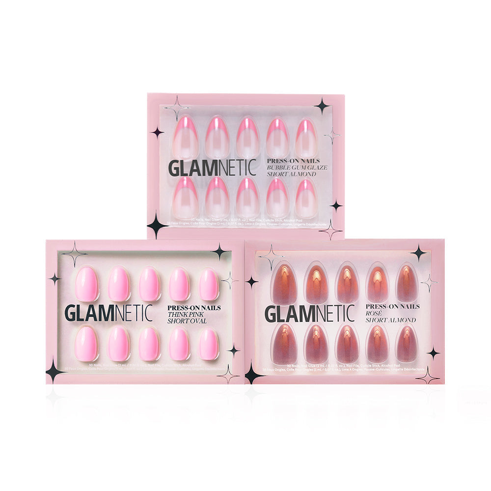 Three boxes of glamnetic press-on nails are displayed, featuring different styles such as Blush Crush in pink and brown shades, with Short Oval and Short Almond shapes, all in signature pink packaging.