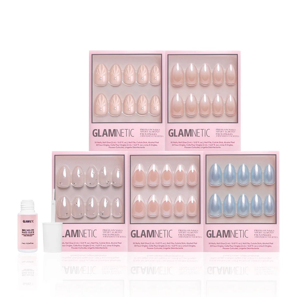 Five pink boxes of glamnetics Anns Bridal Edit press-on nails in assorted nude and blue shades with elegant French tips are arranged in two rows, ideal for bridal looks. An open nail glue bottle sits on the left.