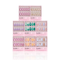 Nine boxes of glamnetic’s Almonds At Sea press-on nails are arranged in a grid, each featuring short almond shapes with ocean-inspired designs, pink packaging, and playful 3D starfish accents.