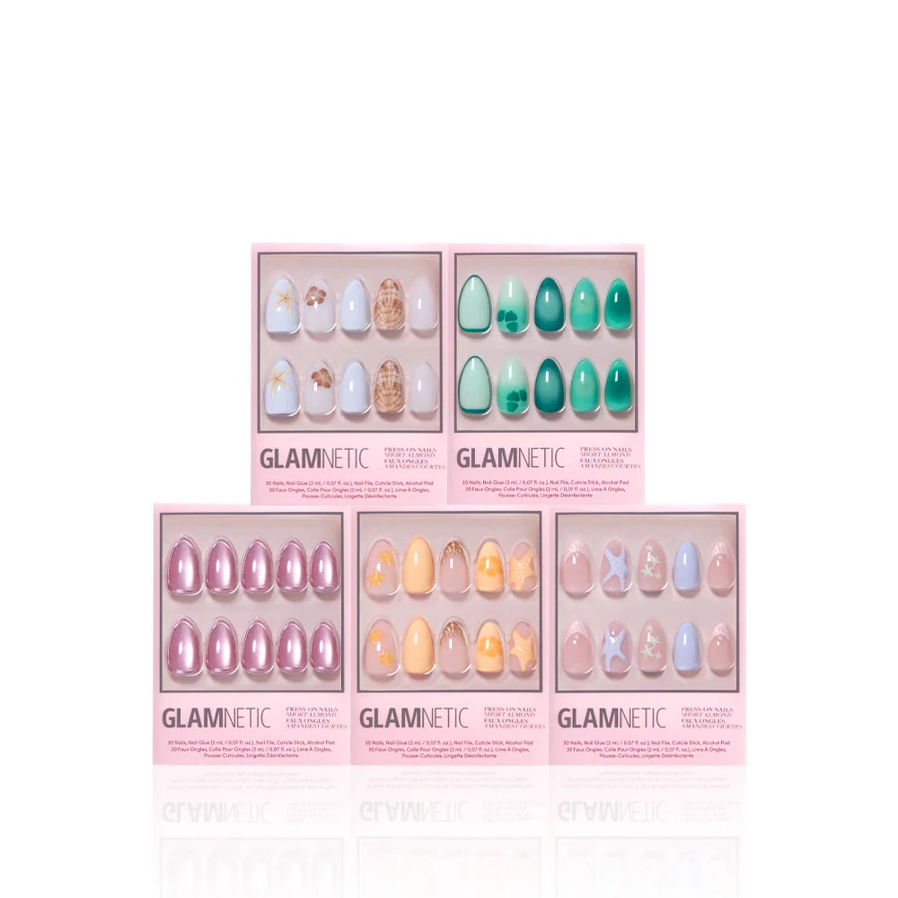 Five boxes of glamnetic’s Ann’s Cove press-on nails are arranged in two rows. Each pink box displays colorful nails with 3D art, pastel, floral, marble, and shiny designs in various shapes.
