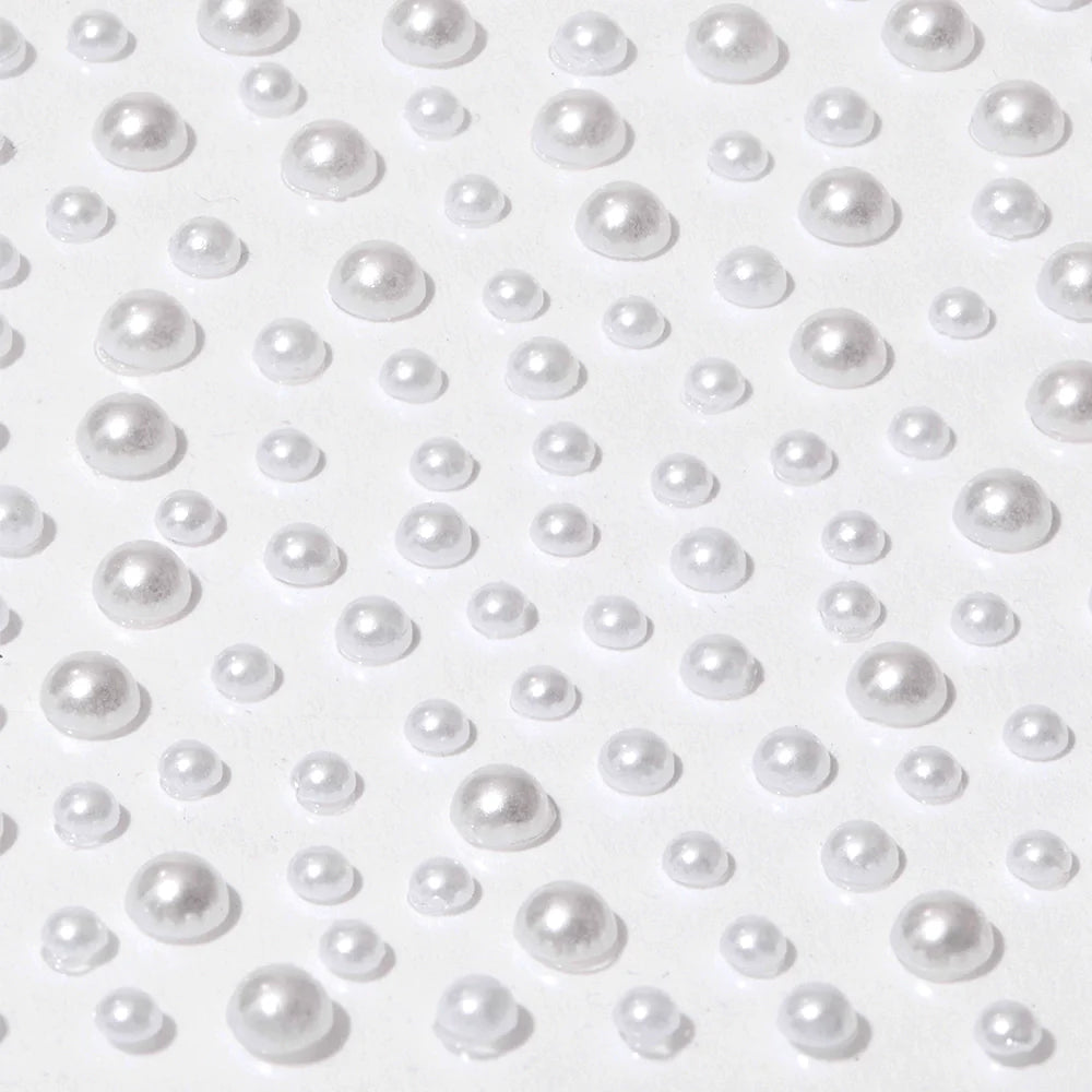 Glamnetics Pearlfect Nail Decal Stickers feature shiny, pearl-like beads of various sizes with a reflective metallic finish, evenly arranged on a flat white surface for an elegant 3D nail art look.