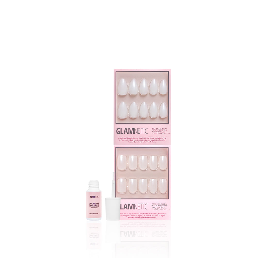 Two pink boxes of glamnetic Bailey + Hailey press-on nails are shown on a white background, displaying white, short almond-shaped, oval nails with a small open bottle of nail glue in front.