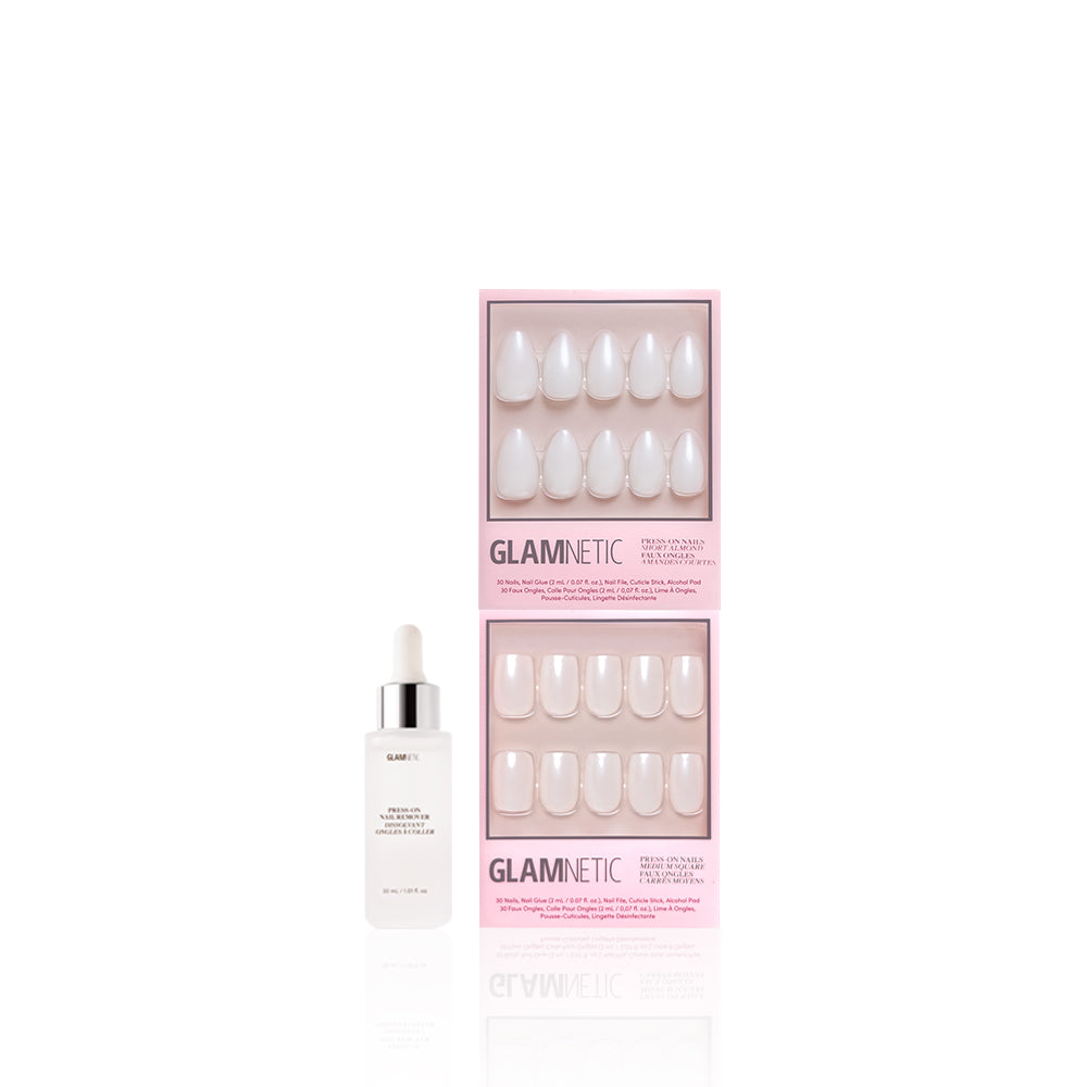 A bottle of glamnetic nail glue stands beside two boxes of glamnetic Bailey + Hailey press-on nails in pink packaging, each showing a set of glossy, neutral glaze Short Almond fit nails.