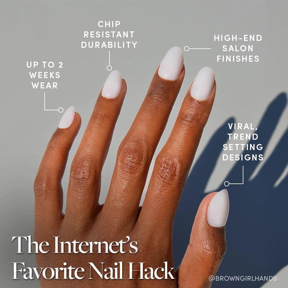 A hand with neatly manicured Clean Girl white short oval nails by glamnetic is shown against a plain gray background, featuring chip-resistant durability, high-end finish, up to 2 weeks' wear, and trend-setting design.