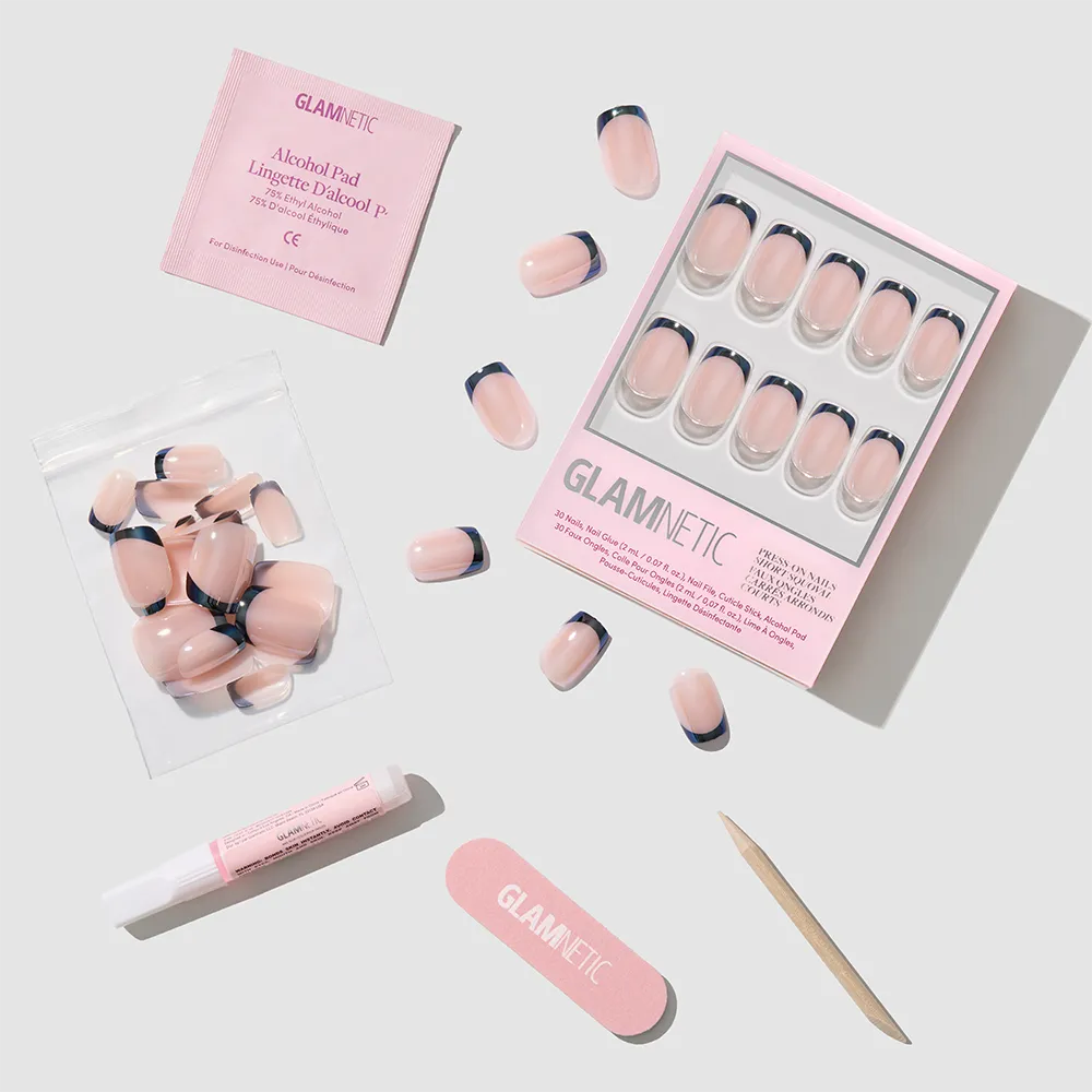 The glamnetic Squid Ink Press-On Nails feature a light pink base, dark French tips, and glazed finish. The set includes a nail file, cuticle stick, glue, alcohol pad, and extra nails on a light gray background.