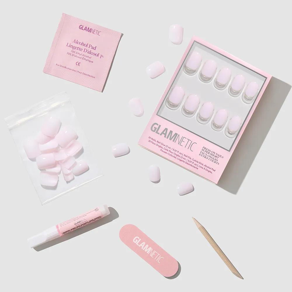 The glamnetic Sweetie Set features light pink press-on nails for a salon-quality mani, shown with adhesive, nail file, cuticle stick, extra nails in a bag, and alcohol pad against a light gray background.