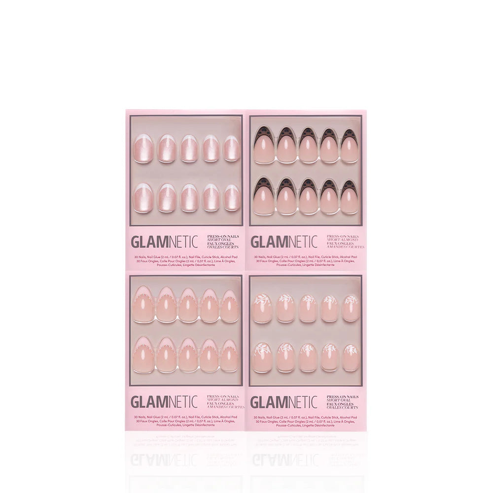 A set of four Glamnetic "The French Kiss" press-on nail boxes featuring modern nude and pink designs—plain, French tip, and white floral—displayed against a white background.
