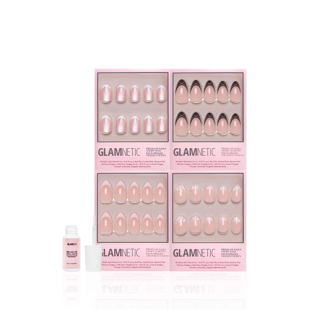 Four pink boxes of glamnetic’s "The French Kiss" press-on nails, featuring modern almond and French tip designs, are arranged in a grid. An open nail glue bottle with a white cap sits in front on a white background.