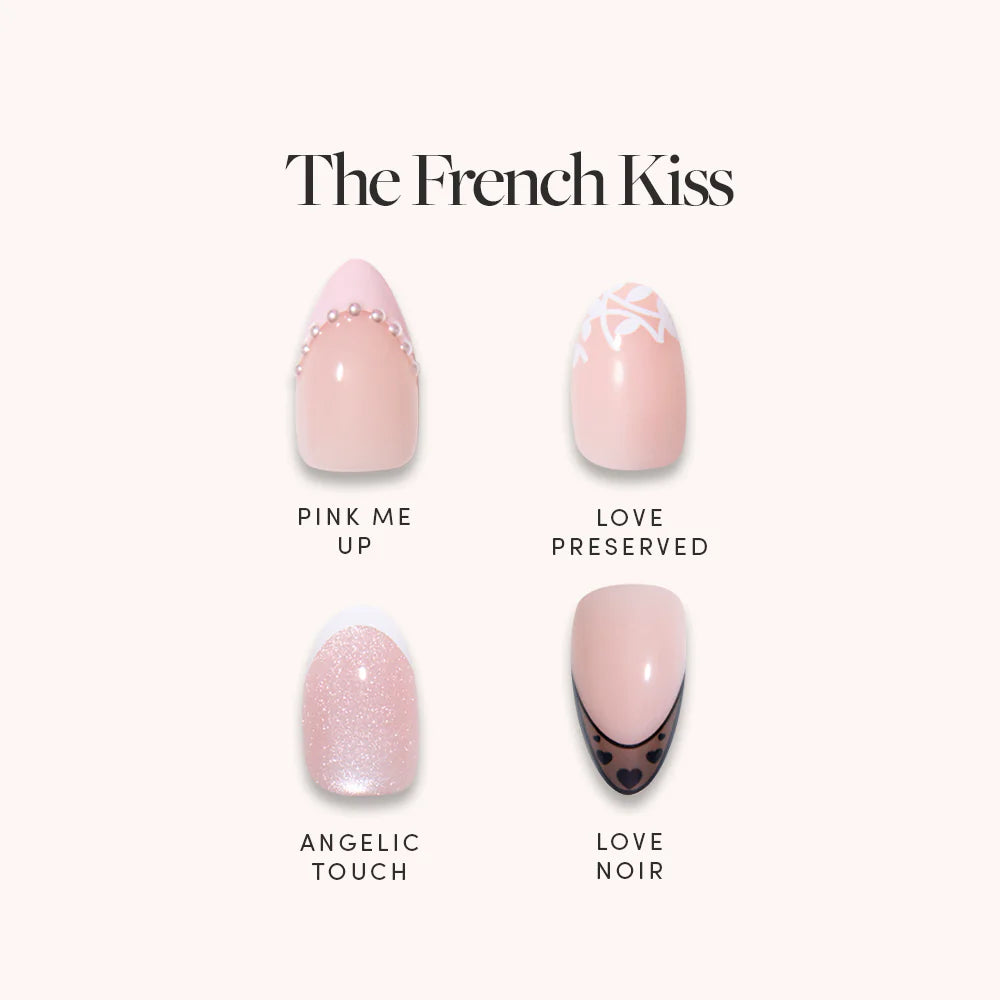 The French Kiss by glamnetic is a set of four almond nails: Pink Me Up (pink with pearls), Love Preserved (white floral tips), Angelic Touch (glittery pink), and Love Noir (black French tips with hearts).