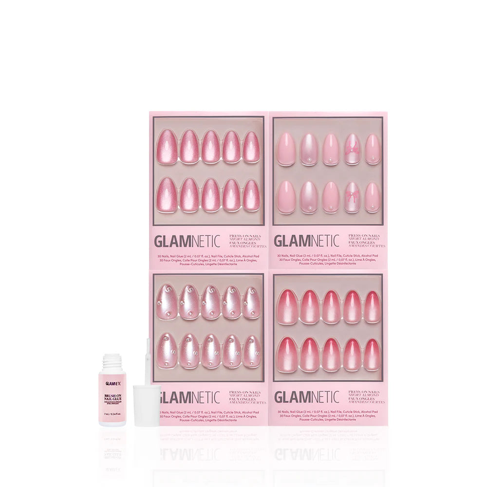 Four sets of glamnetic Velvet Valentine pink press-on nails with blush designs are displayed in rectangular boxes, alongside a small white bottle of nail glue with its cap off, all on a white background.
