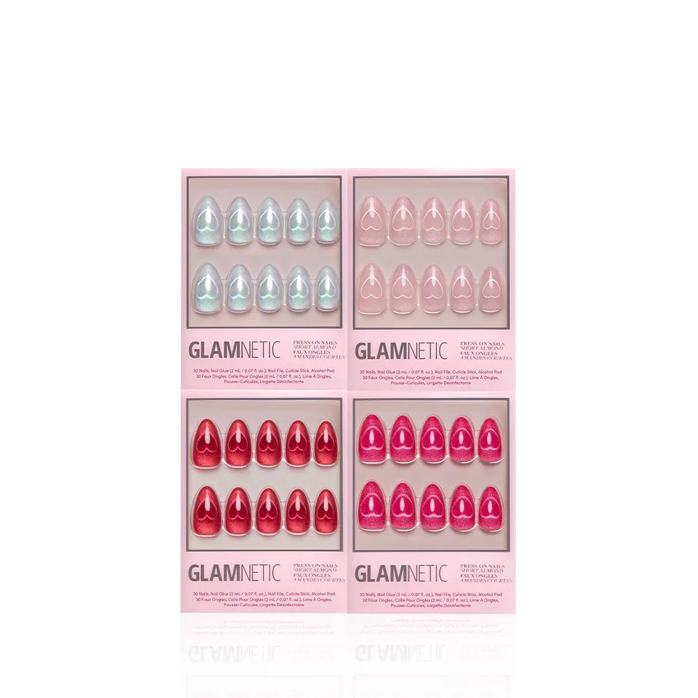 Four boxes of glamnetic Cupid's Magnetic Hearts press-on nails—featuring almond shapes in light blue, light pink, red, and bright pink—are arranged in a grid on a white background. Each box displays ten nails through a clear window.