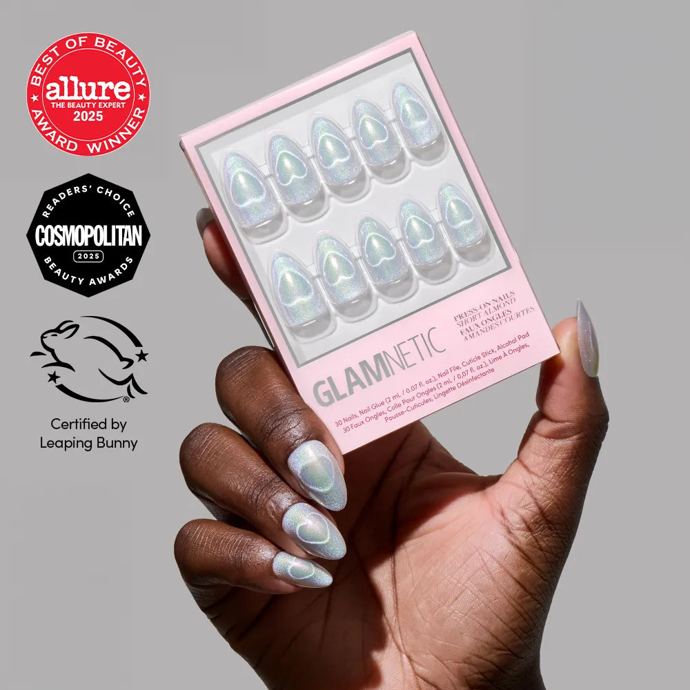 A hand with iridescent, oval-shaped holographic Electric Lover nails by glamnetic holds a matching box. Three beauty award badges and the Leaping Bunny cruelty-free logo are displayed next to the hand.