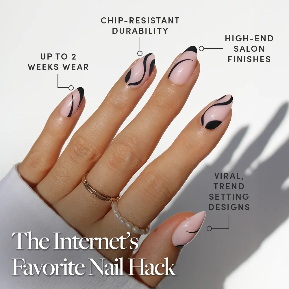 A hand with long, almond-shaped nails in glamnetic’s Ink Wave design—pink base and black abstract art. Boasts salon-quality finish, chip resistance, trendy style, durability, and up to 2 weeks of flawless wear.