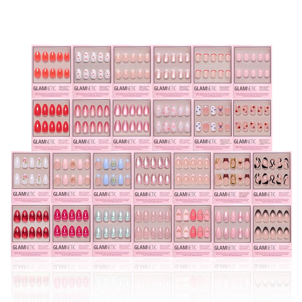 The glamnetic Love Notes Collection features 20 press-on nail kits in pink packaging, with almond and coffin shapes in pink, nude, red shades, plus playful patterns or faces, all neatly arranged in rows.
