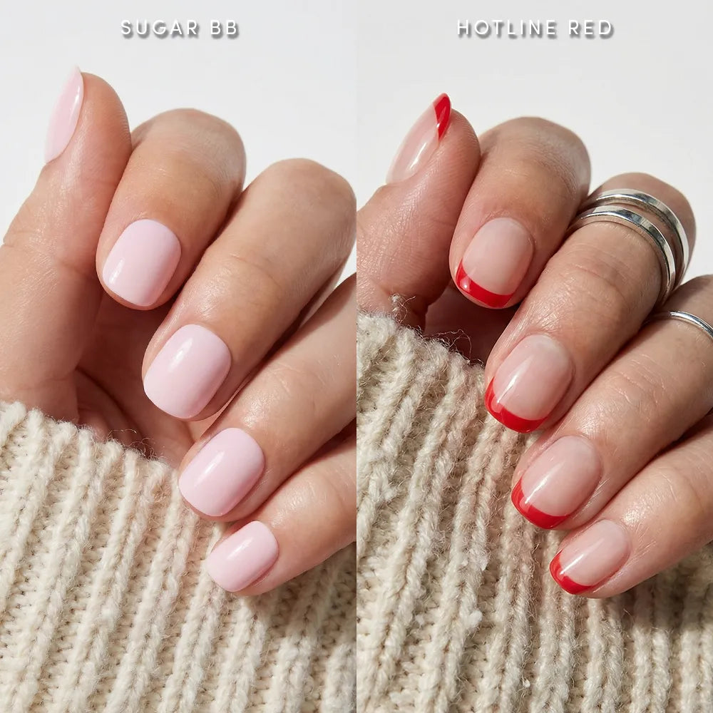 The left hand wears glamnetic's Super Short & Sweet set—pink nails with rounded tips—while the right shows clear nails with glossy red French tips. Both hands have silver rings, and a cream knit sleeve partially covers the right hand.