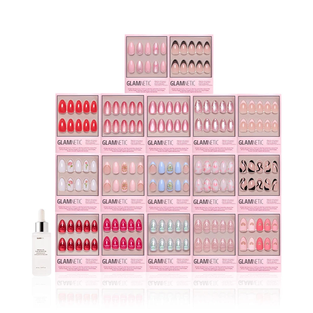 A pyramid display of 15 pink boxes of glamnetic's The Almond Crush press-on nails, featuring short almond designs in assorted colors, with a small white nail glue bottle placed in front.