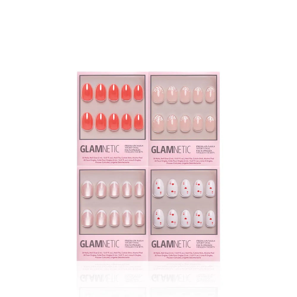 Glamnetic's The Oval Affair includes four pink-packaged press-on nail sets: solid coral, nude with white designs, pearlescent nude, and nude with small red dots for a soft-luxury classic manicure.