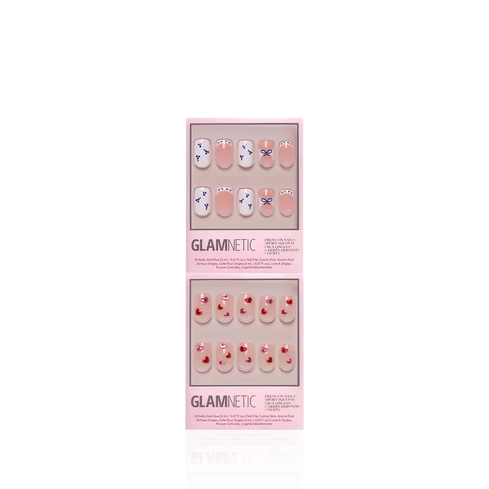 Two sets of glamnetic press-on nails in pink packaging: The Sweet Squovals set with purple and white squoval designs on top, and a cute pink set with small red cherry accents below. Both sets are displayed vertically.