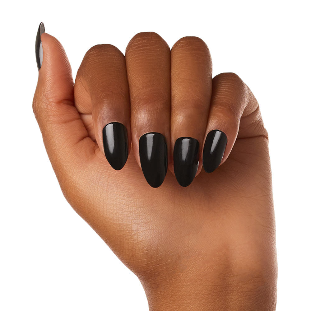 A hand with medium brown skin displays long, almond-shaped, glossy black glamnetic Boba vegan cruelty-free nails against a white background.