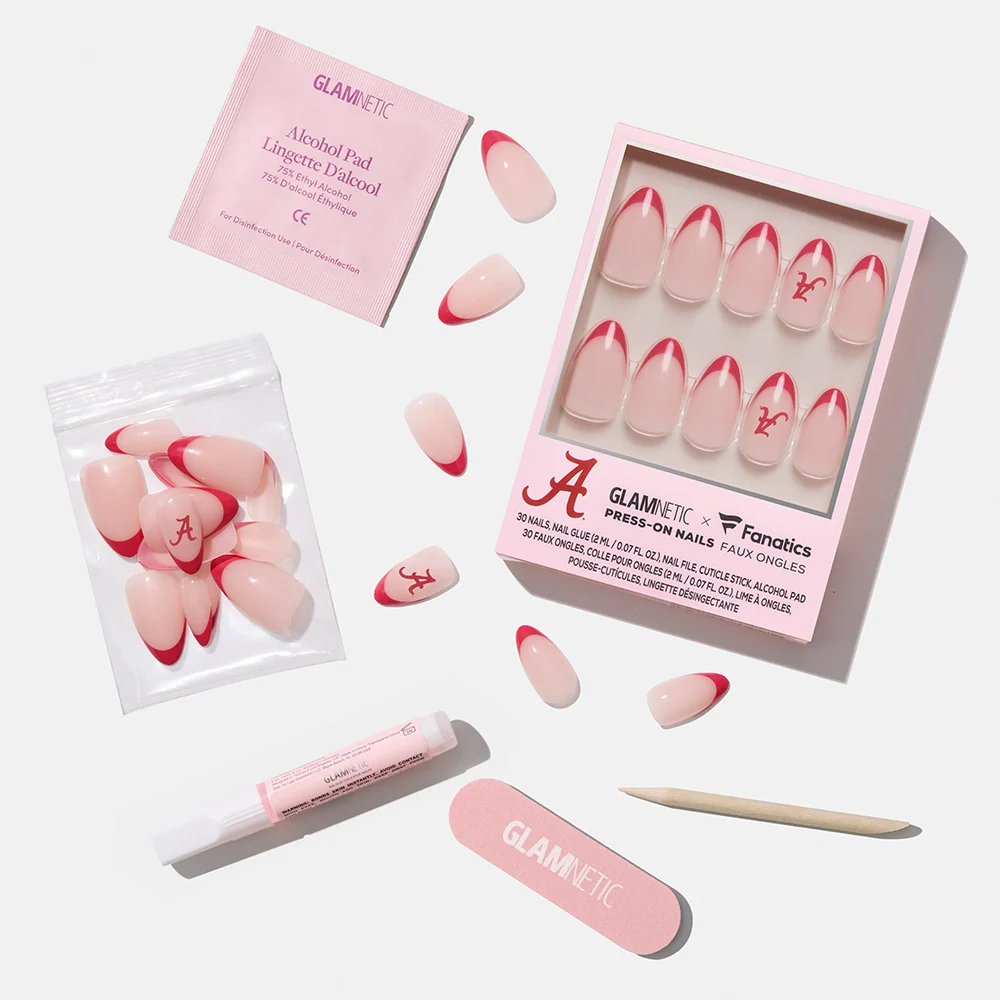 The glamnetic Alabama Crimson Tide Press-On Nail Set features pink and red nails with team logos and red tips. Includes alcohol pad, nail glue, file, cuticle stick, and extra nails, all displayed on a white background.