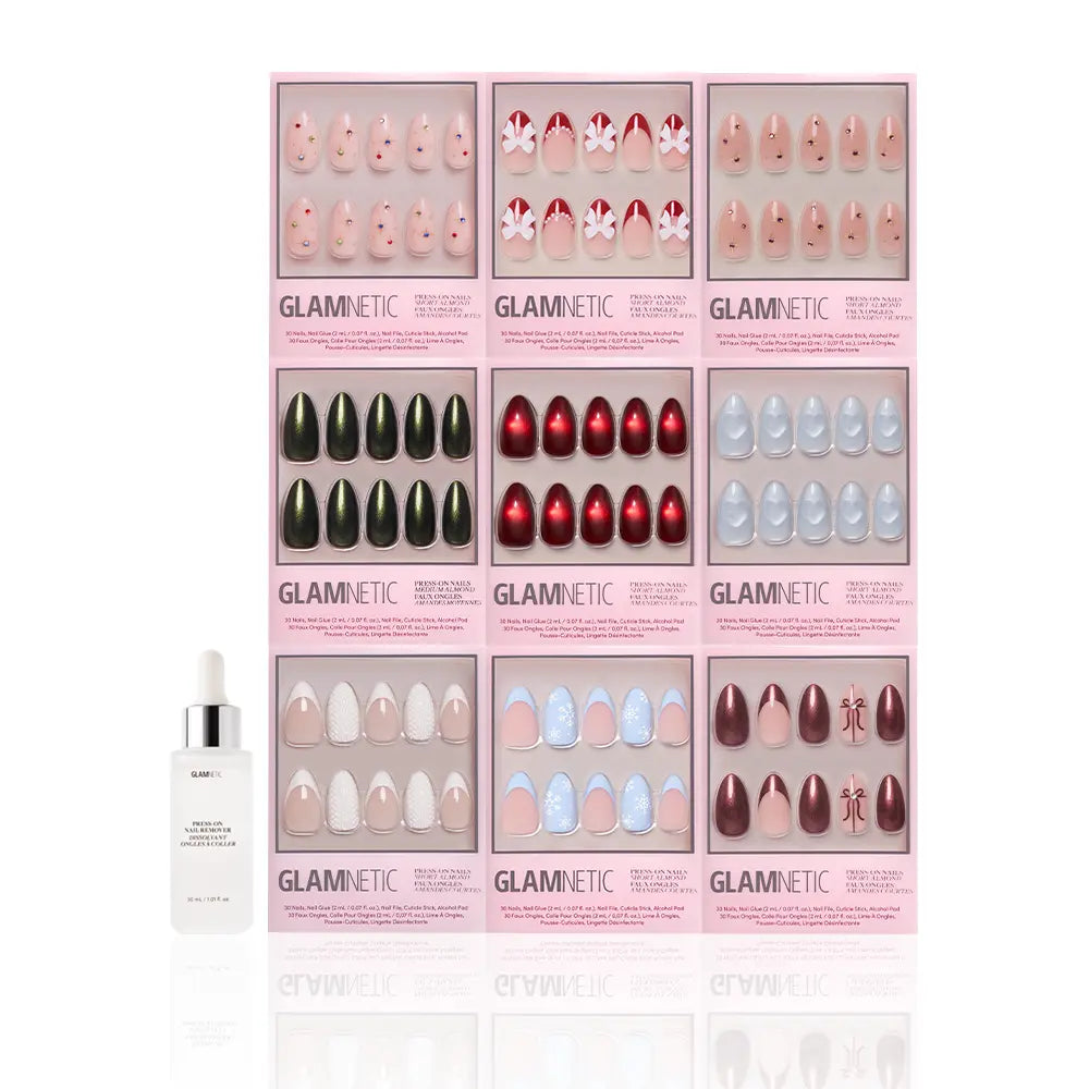 Nine boxes of glamnetic Almond Joys press-on nails are arranged in a grid on a white background, featuring styles like glitter French tips and holiday designs, with a small white dropper bottle placed in front.