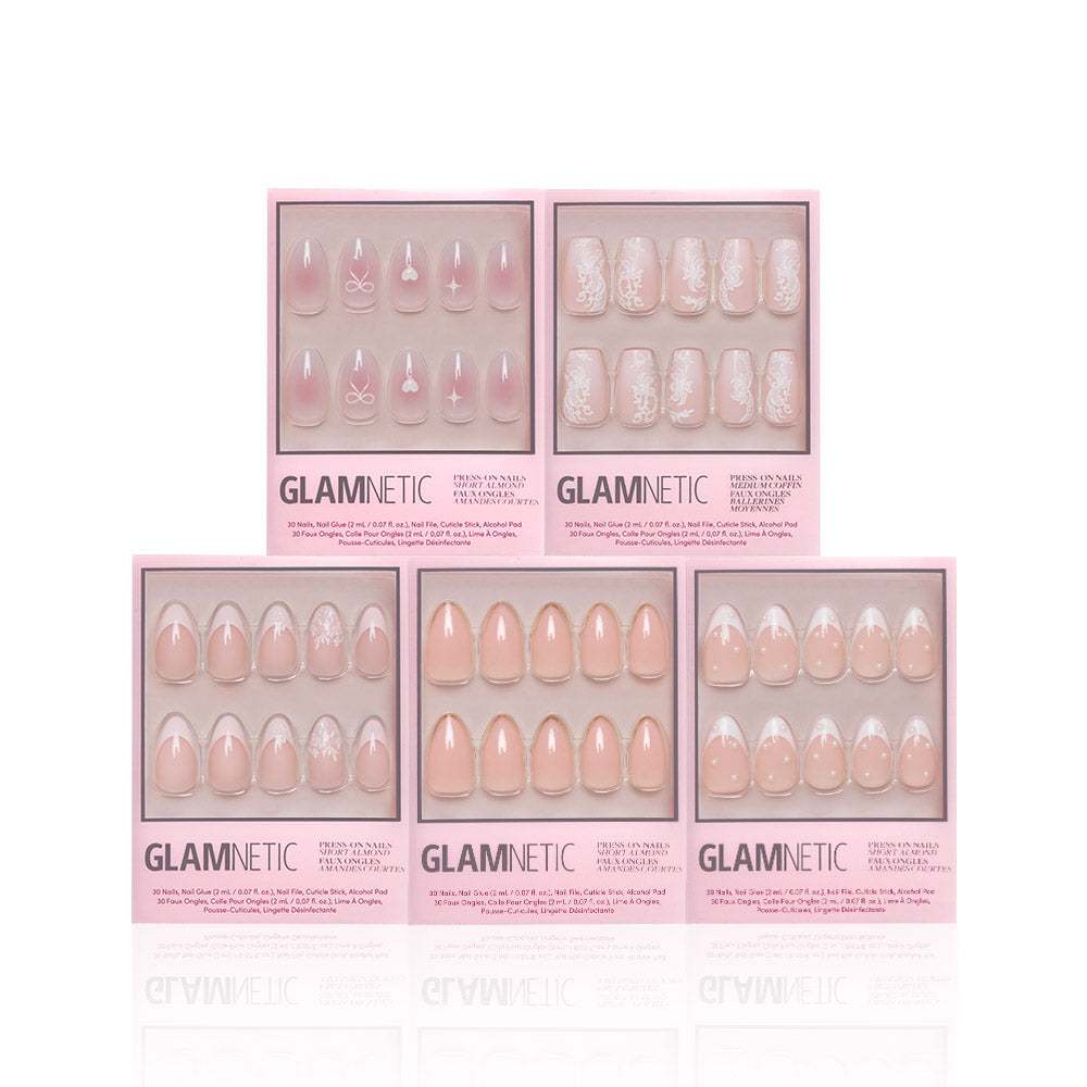 Five boxes of glamnetic Anns Sweethearts press-on nails in assorted nude and pink designs, featuring French tips, short almond shapes, and white floral, heart, and bow patterns, displayed on a white background.