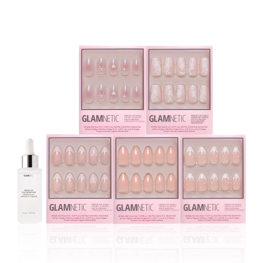 Five boxes of glamnetic Anns Sweethearts press-on nails in soft pink and white French tips, short almond style, are arranged in two rows with a white bottle of glamnetic cuticle oil and dropper on the left.