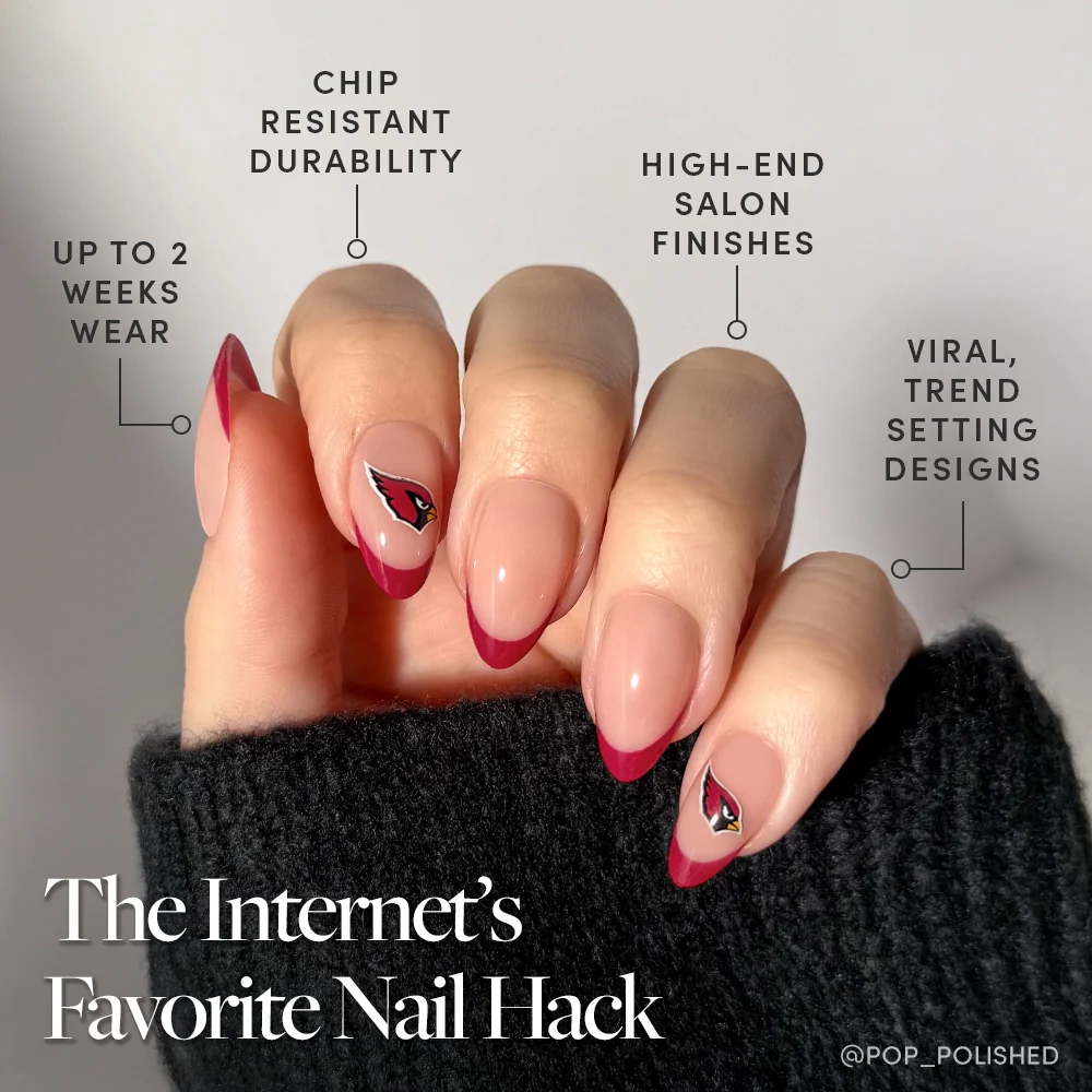 A hand shows off the glamnetic Arizona Cardinals Press-On Nail Set with long, almond French tips, a pink base, and dark red accents. Text highlights its chip resistance, salon-quality finish, trendy style, and lasting wear.