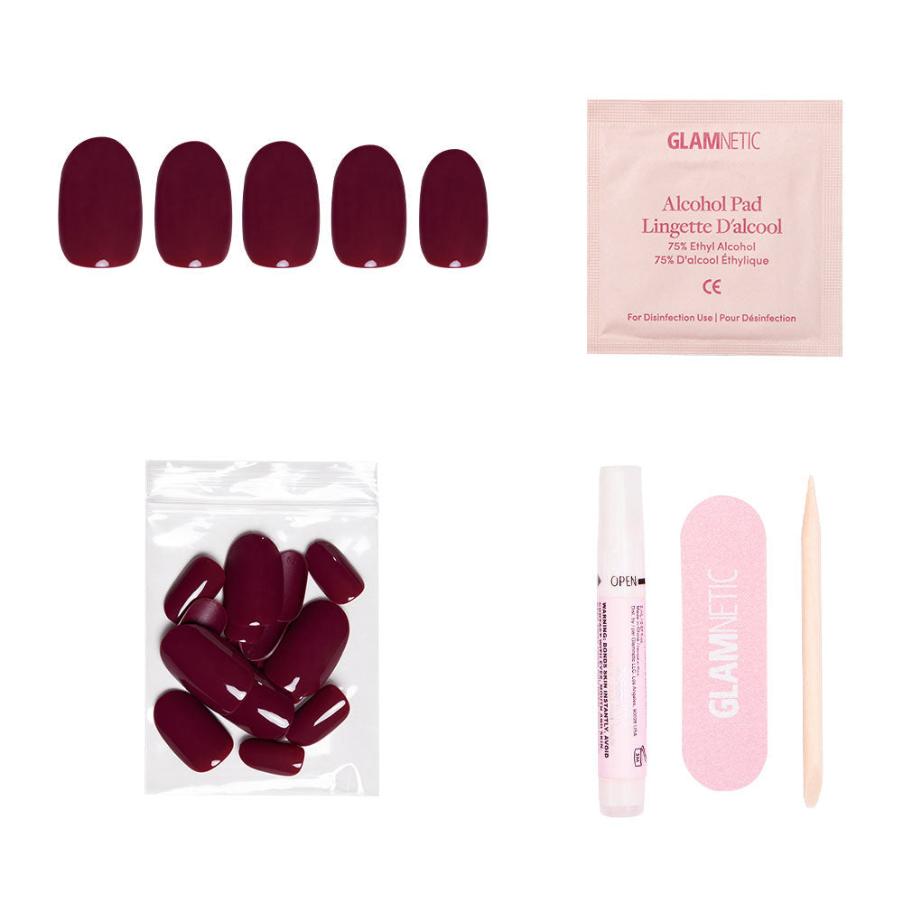 The glamnetic Berry Maroon set features five press-on nails, extra nails, glue, an alcohol pad, a pink nail file, and a wooden cuticle stick—ideal for achieving a Fall Forest-inspired look on a white background.