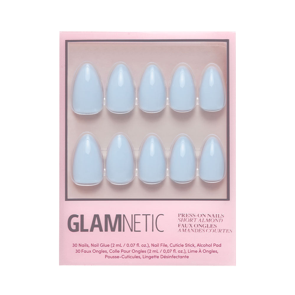 A box of glamnetic Blueberry Milk press-on nails in a short almond shape and glossy light blue finish, arranged in two rows of five and displayed in pink packaging.