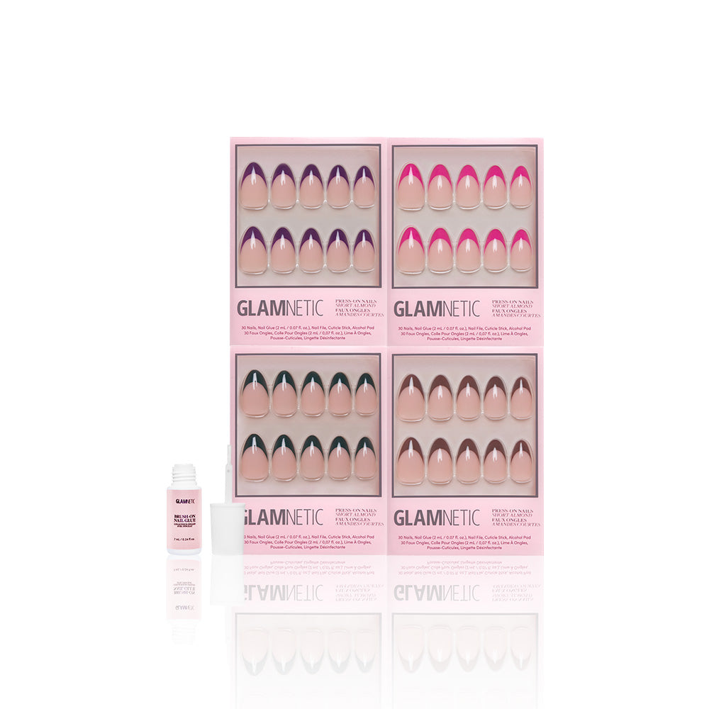 Four boxes of glamnetic Bonbon Babe press-on nails in assorted colors and styles, including French Tip and Almond, are arranged on a white background. A small open bottle of vegan and cruelty-free nail glue is on the left.