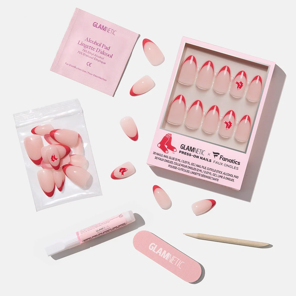 The glamnetic Boston Red Sox Press-On Nail Set features pink nails with red tips and the team logo, displayed on a white background with a file, cuticle stick, adhesive, alcohol pad, and nails both in and out of the box.