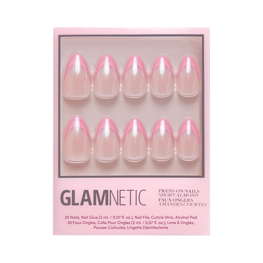 The Bubble Gum Glaze kit by glamnetic features 10 almond-shaped press-on nails with pink French tips, plus nail glue, a cuticle stick, and an alcohol pad in branded packaging.