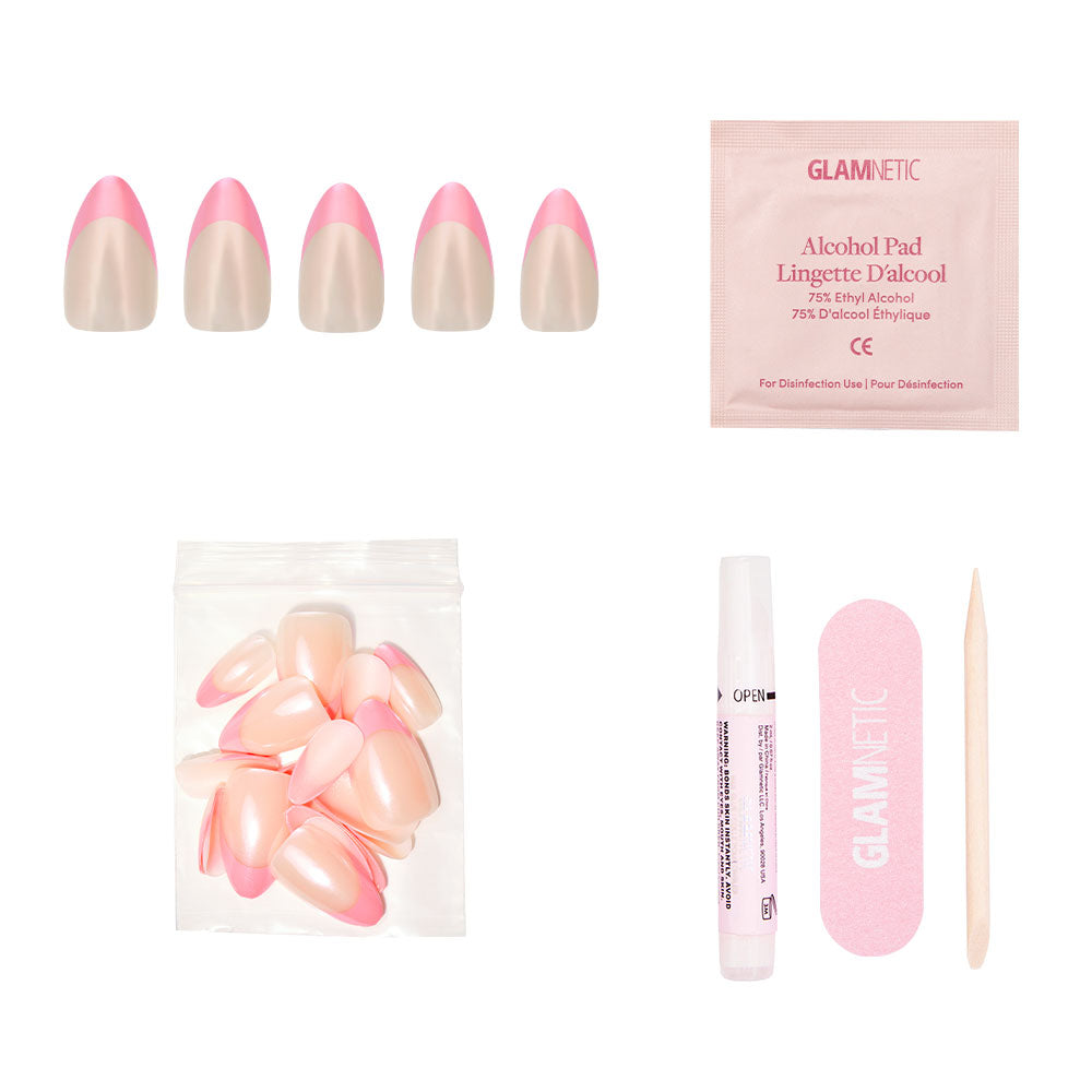 The glamnetic Bubble Gum Glaze press-on nail kit features almond-shaped pink French tips, extra nails, nail glue, an alcohol pad, a pink nail file, and a wooden cuticle stick—all arranged on a white background.