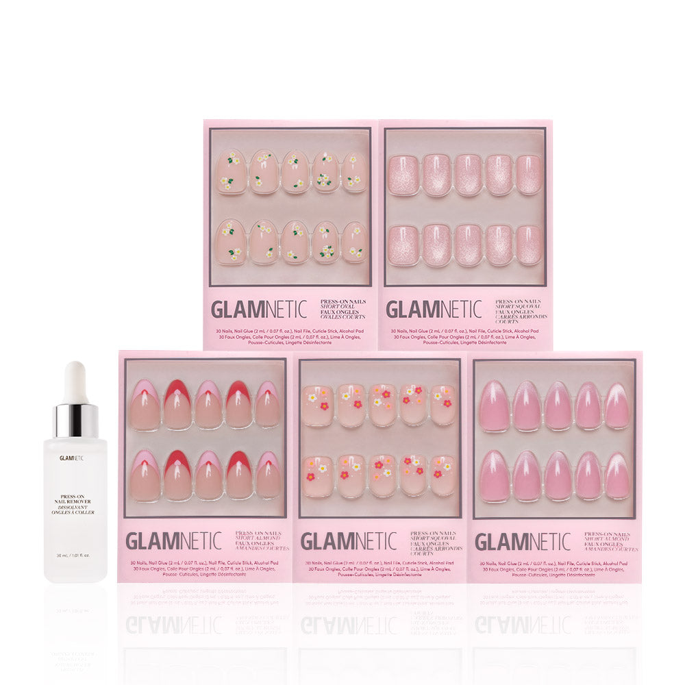 Six boxes of glamnetic Budding Romance press-ons in pink and floral designs are arranged in two rows, with a white Glamnetic Press-On Nail Remover bottle to the left of the bottom row.