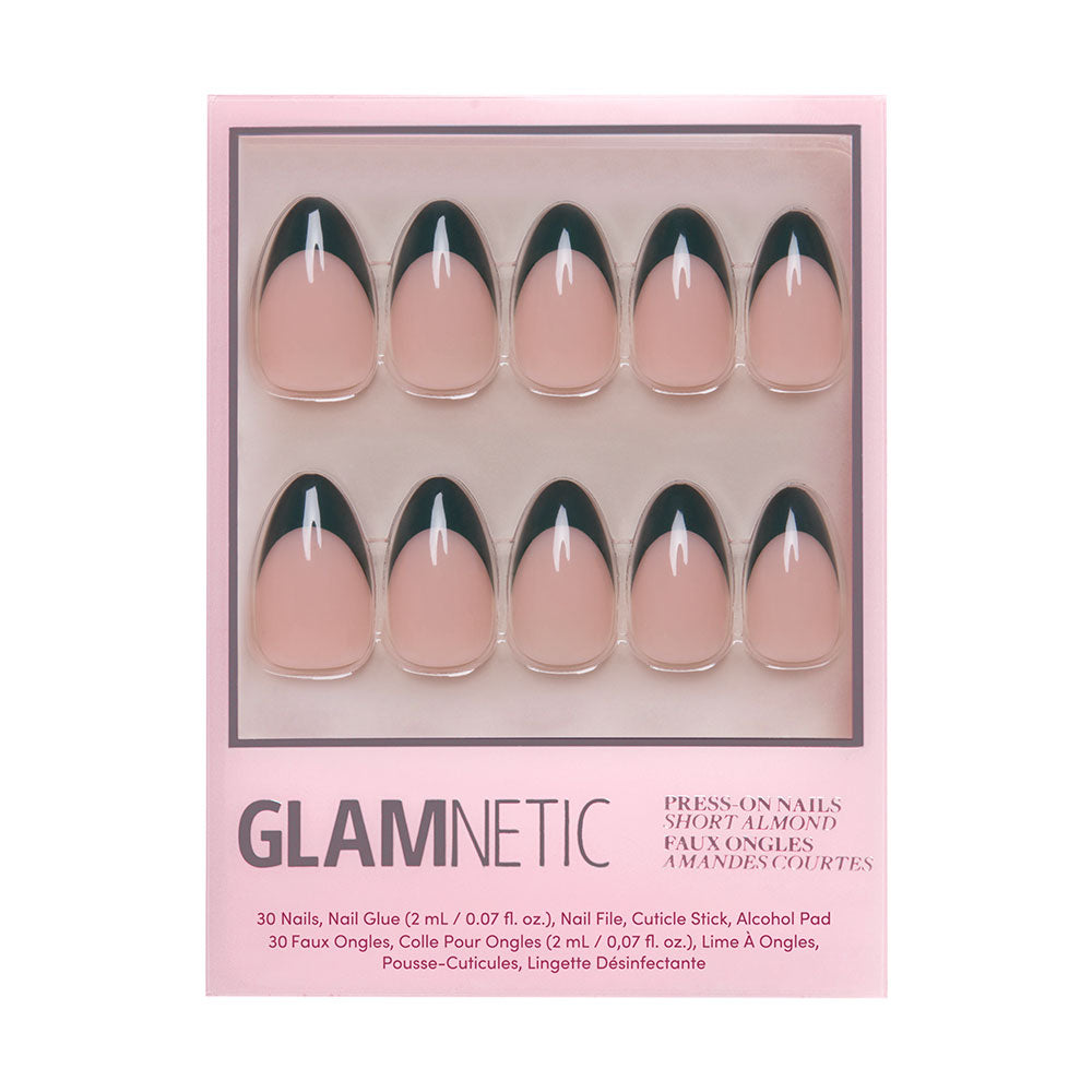 The Château Nail Set by glamnetic features press-on short almond nails with a nude base and dark green French tips, arranged in two rows inside chic pink packaging.