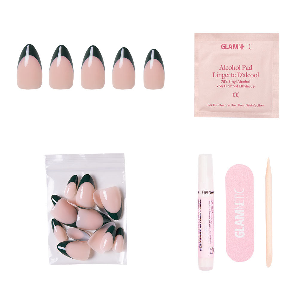The glamnetic Château Nail Set includes short almond nude nails with dark green French tips, an alcohol pad, extra nails in a zip bag, nail glue, a pink file, and a wooden cuticle stick—displayed on a white background.